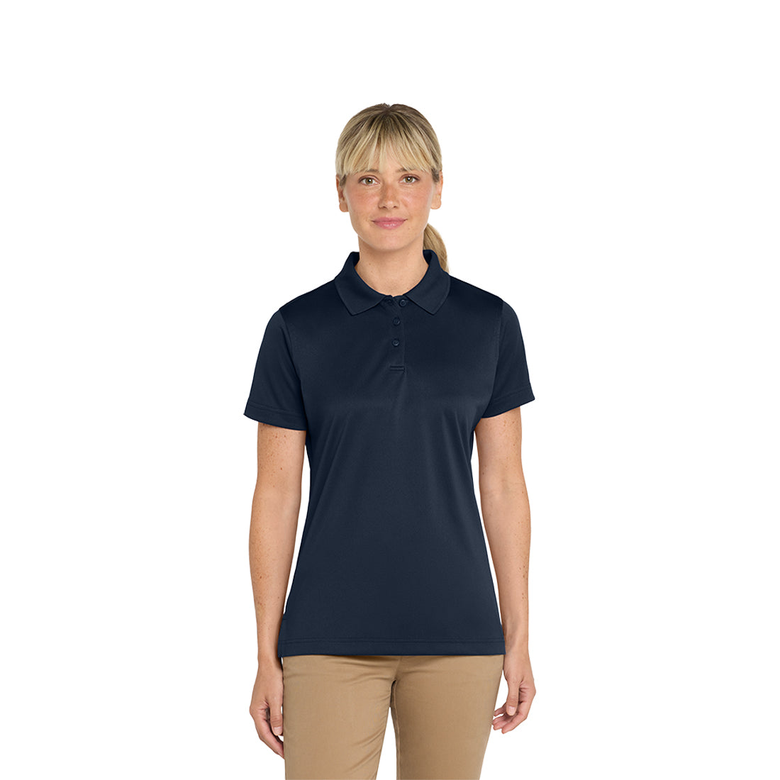 Woman wearing a navy polo shirt and beige pants on a white background