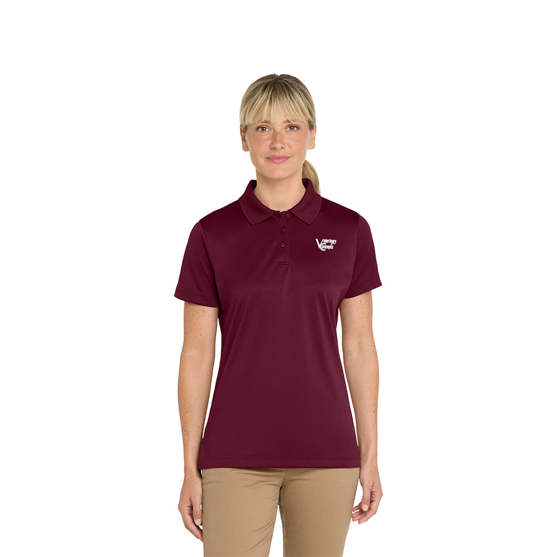 Woman wearing a maroon polo shirt and beige pants on a white background