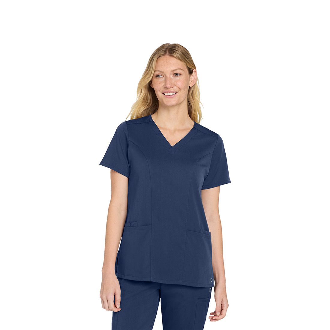 Woman wearing a navy blue scrub top on a white background