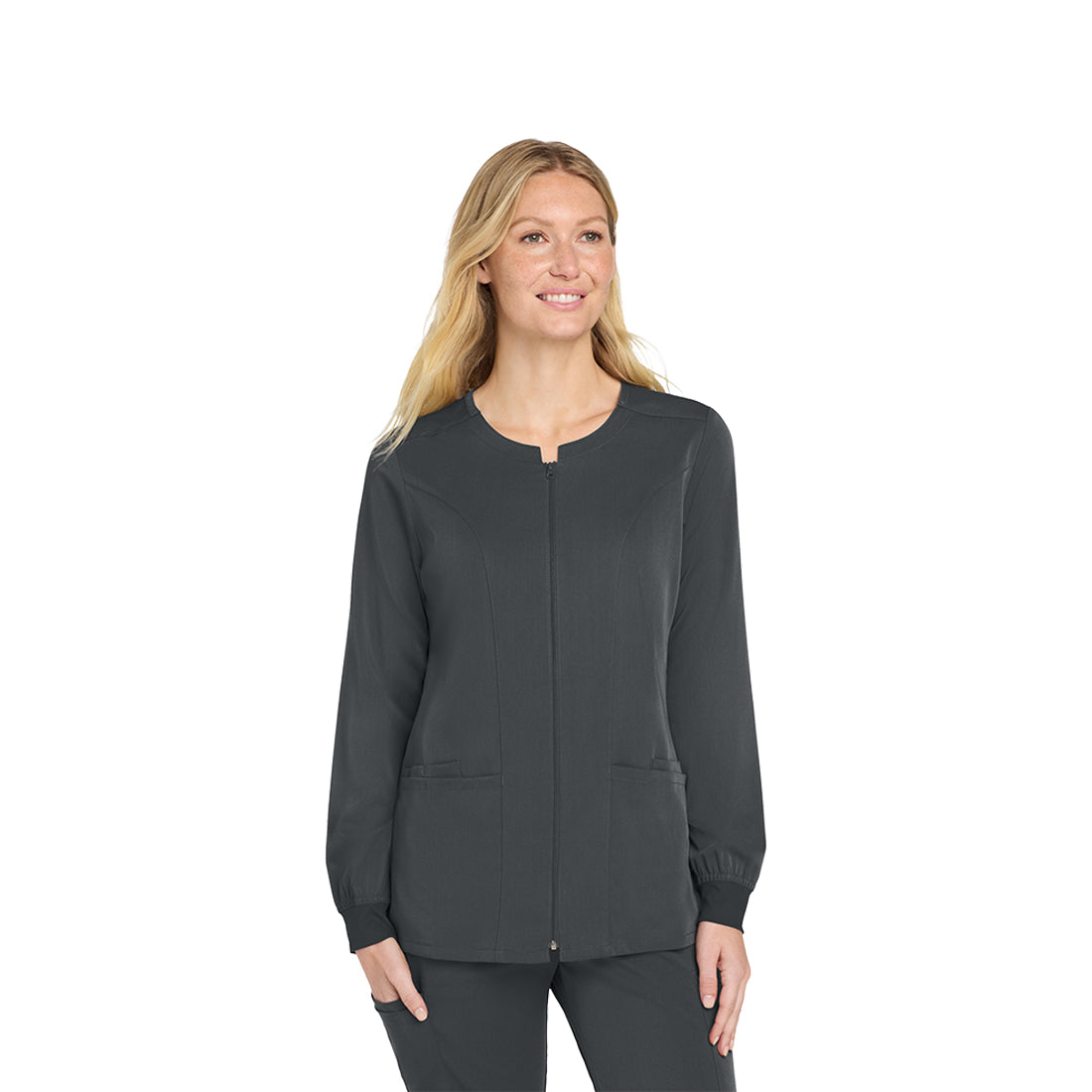 Woman wearing a gray scrub top on a white background