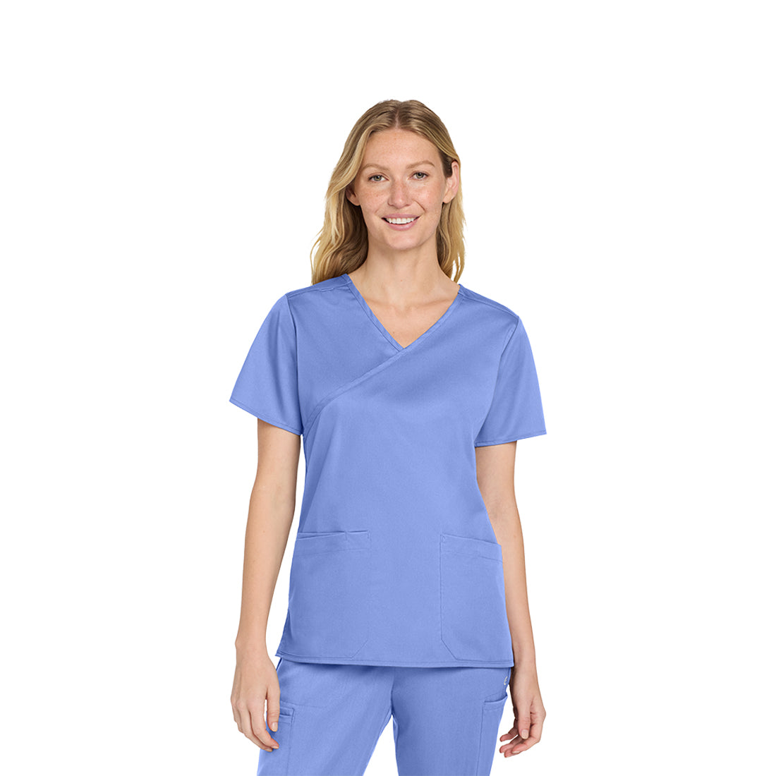 Woman wearing a light blue scrub set on a white background
