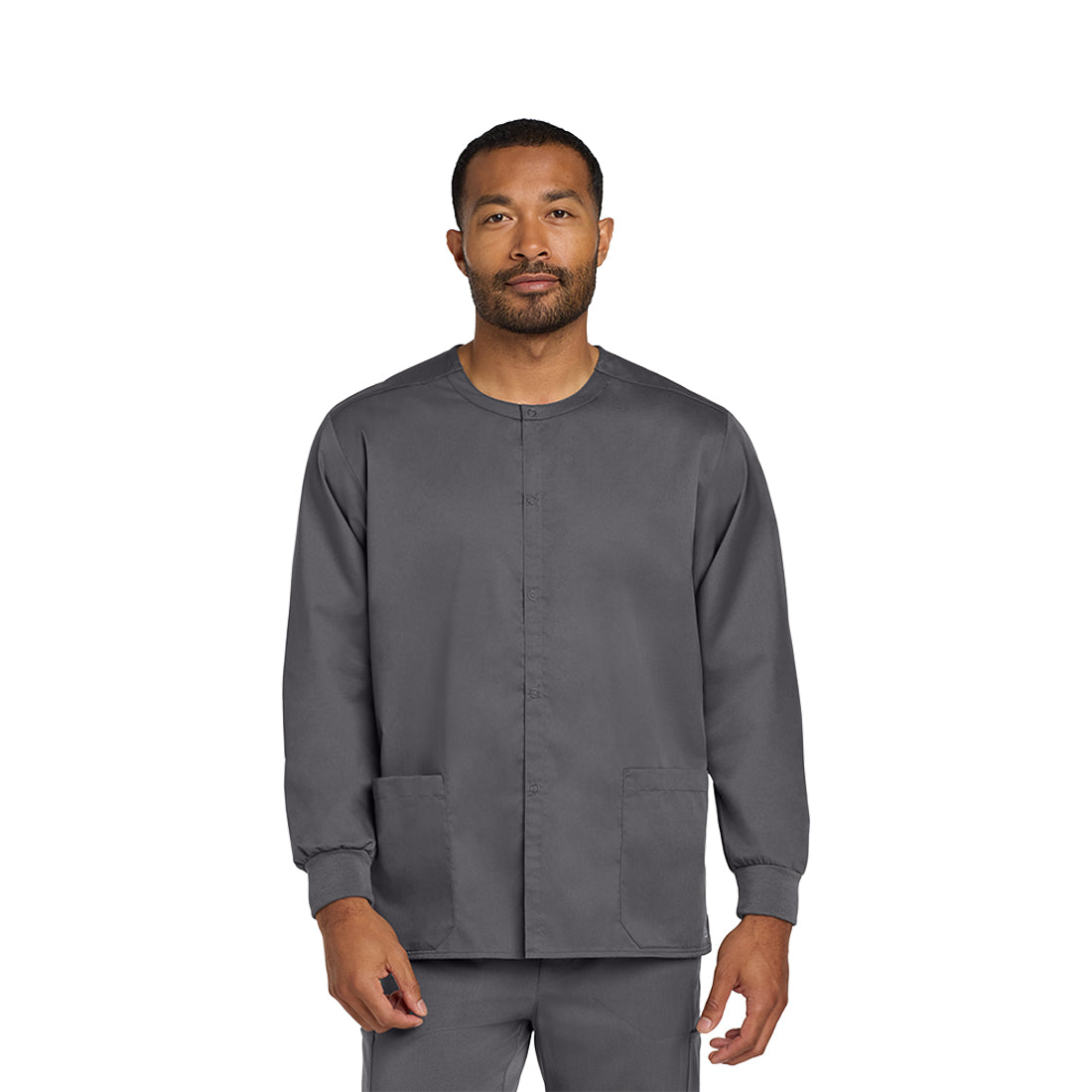 Man wearing a gray scrub set on a white background