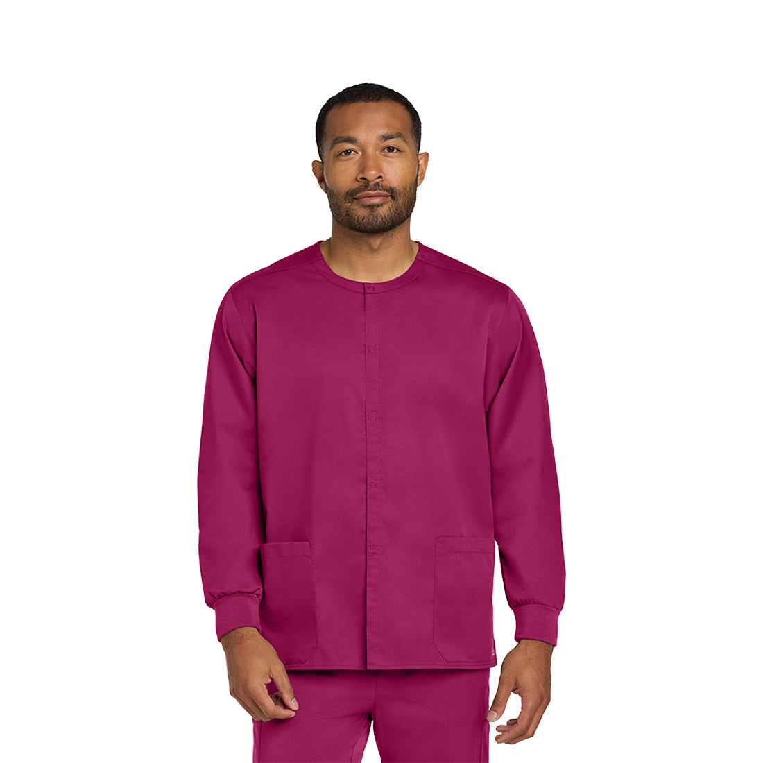 Man wearing a wine scrub set on a white background