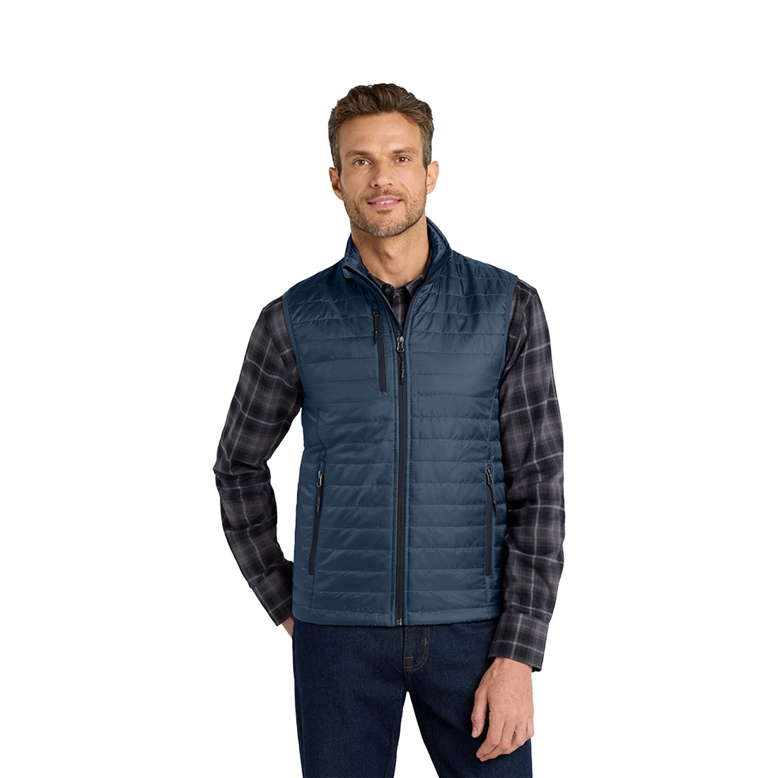 Man wearing a blue quilted vest over a gray shirt on a white background